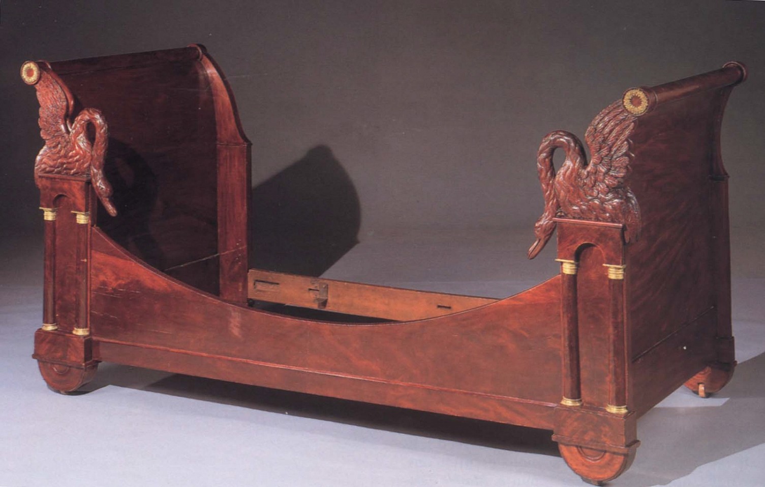 19th Century FRENCH ,   Empire Ormolu-Mounted Mahogany Bed  ,  1800-1825  
  Mahogany ,  46 x 72 x 36 in. (116.8 x 182.9 x 91.4 cm)  
  Each head and footboard with outscrolled rounded top rails fitted with ormolu floral wreaths above elaboratelly carved swans and arcaded niche flanked by rounded pilasters with ormolu capitals and terminals ending in a semi-circular base on casters joined by a downcurved rail.  
  FRE-002-FU  
   Appraisal Value : $0.00 
 Location : $0.00 
 User3 : $0.00